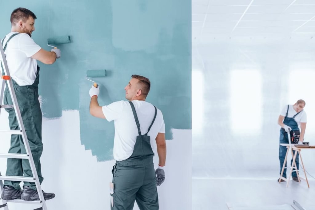 Two painters rolling a fresh coat of paint on an interior wall