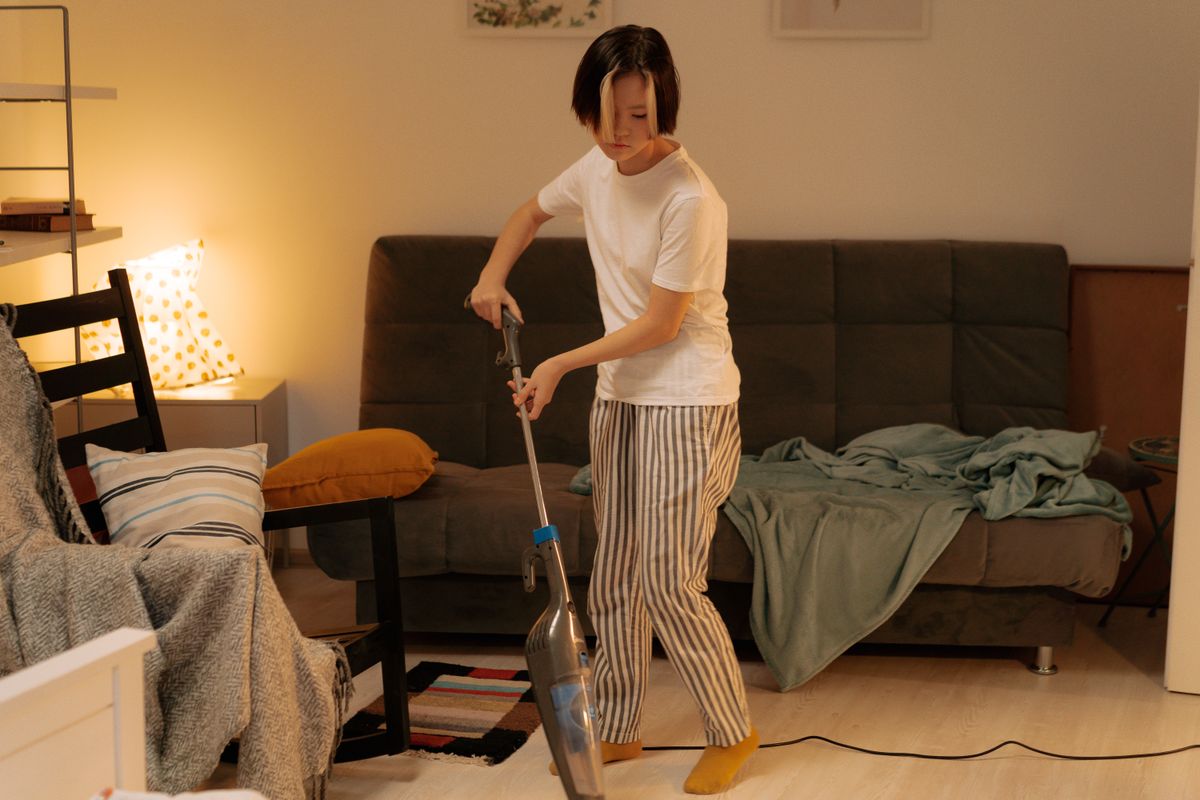 Woman vacuuming a living room floor